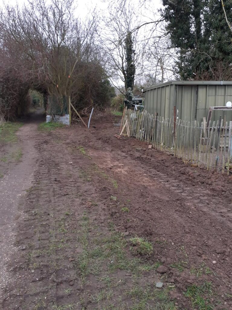 Back filling the trenches by hand